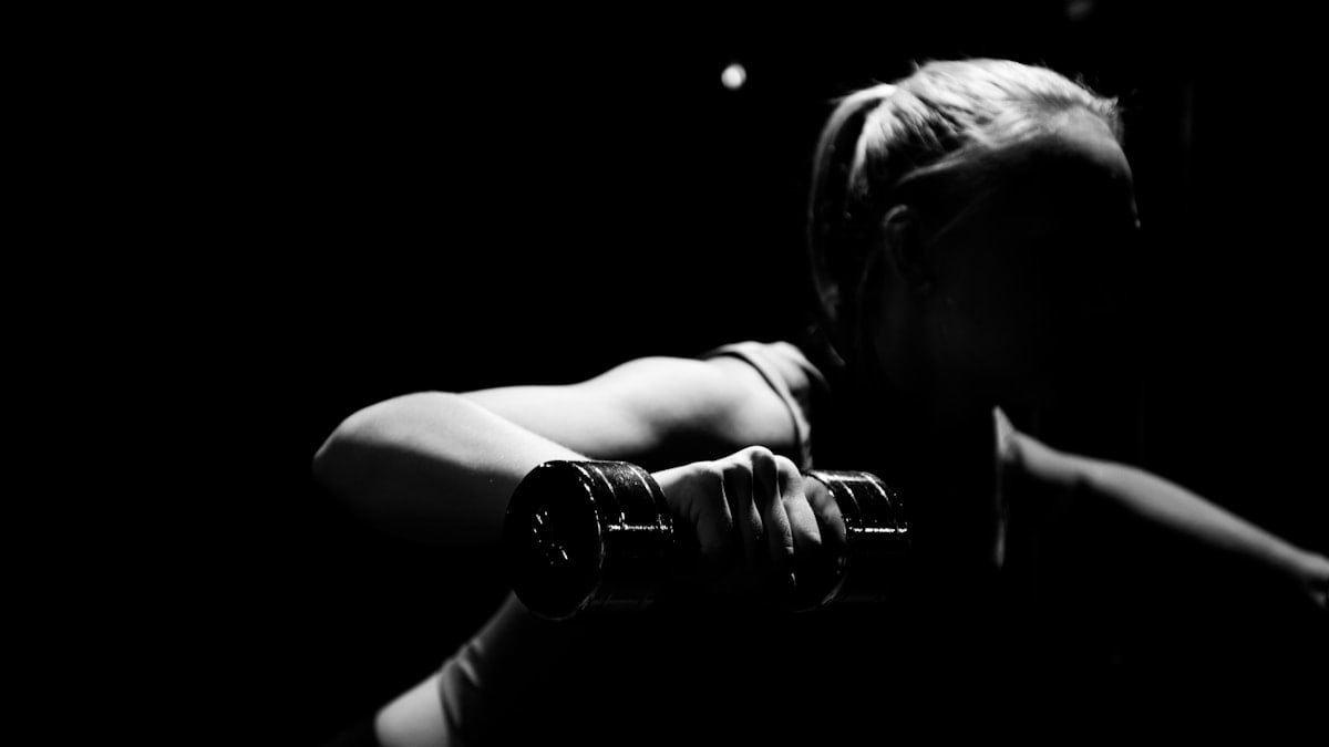 woman holding dumbbell